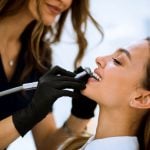 female with open mouth at the dentist