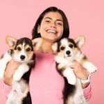 happy girl holding puppies